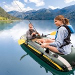 Couple fishing from inflatable boat on mountain lake