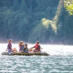 intex seahawk 4 boat set 68351 Friends fishing from inflatable raft on calm lake