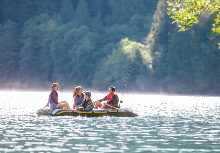 intex seahawk 4 boat set 68351 Friends fishing from inflatable raft on calm lake