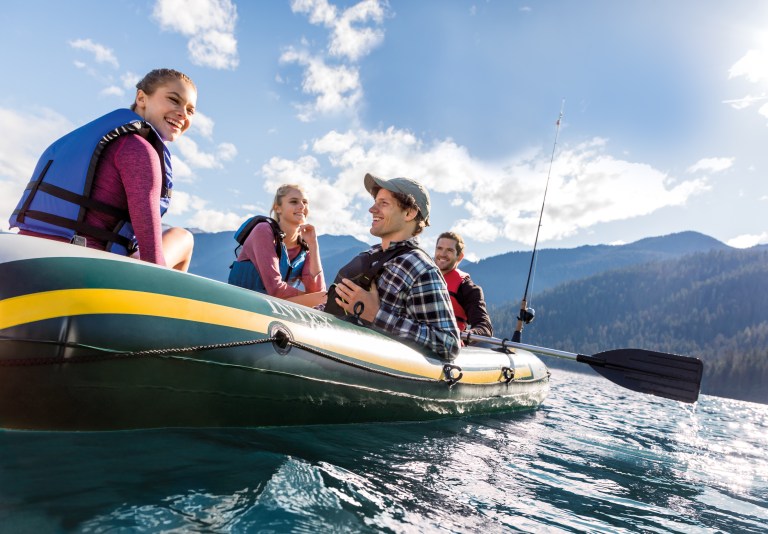 intex seahawk 4 boat set 68351 Friends boating on mountain lake with fishing rod