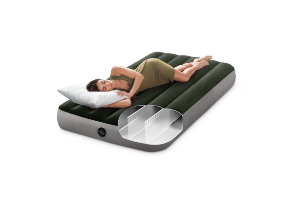 intex single (twin) classic airbed with built in pump 64761 Woman resting on green inflatable air mattress