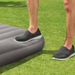 intex single (twin) classic airbed with built in pump 64761 Person stepping on inflated air mattress outdoors