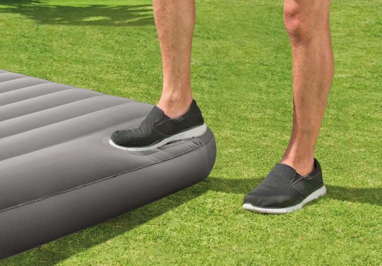 intex single (twin) classic airbed with built in pump 64761 Person stepping on inflated air mattress outdoors