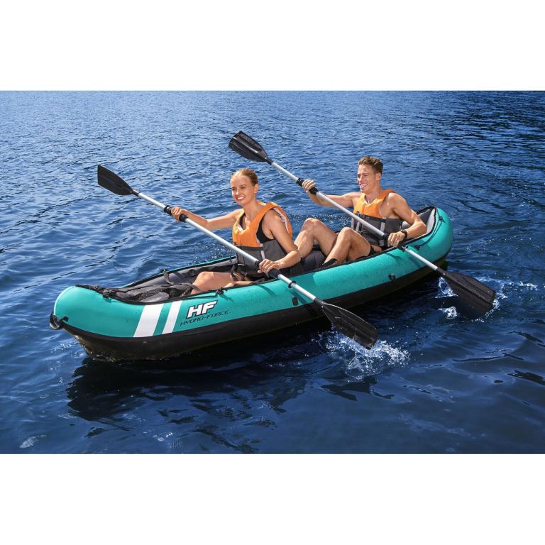 Couple kayaking on blue water in inflatable kayak