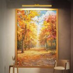 Framed autumn park painting above chair