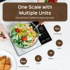 Digital kitchen scale weighing fresh salad bowl