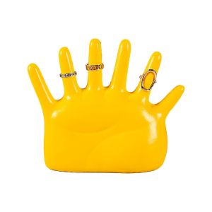 Yellow hand-shaped ring holder with jewellery