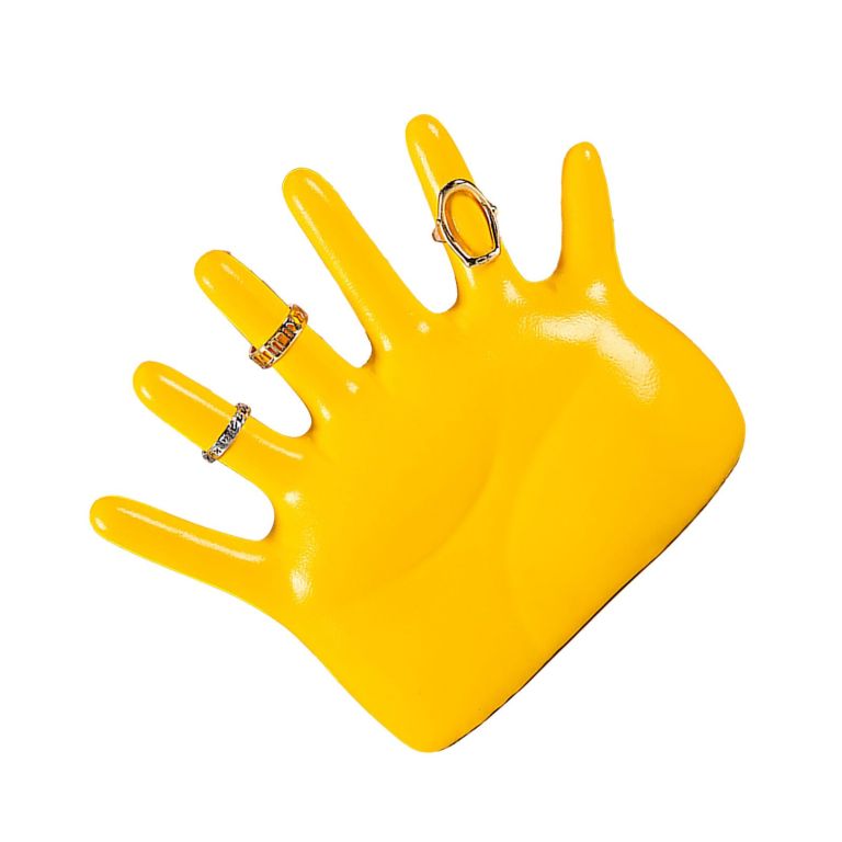 Yellow mannequin hand displaying decorative rings