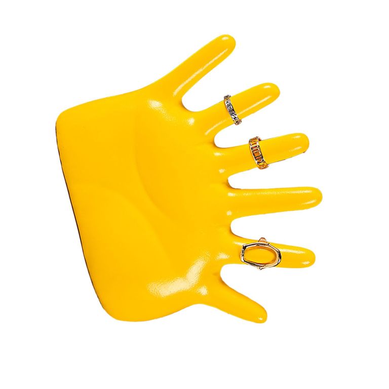 Yellow mannequin hand displaying assorted decorative rings