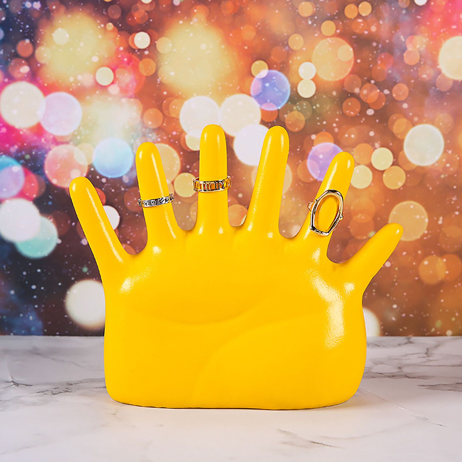 Yellow hand jewellery stand with rings