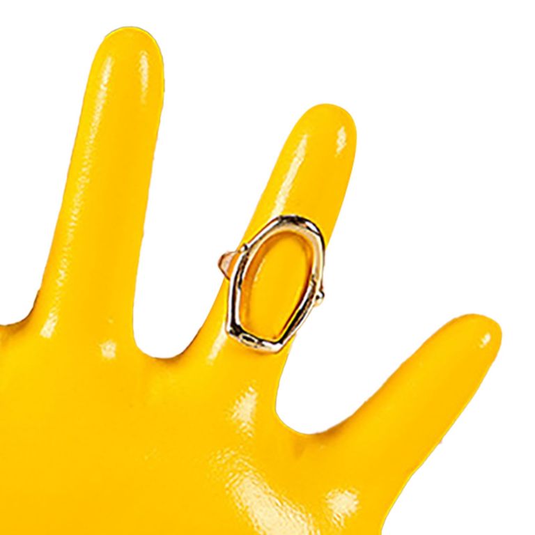 Yellow mannequin hand wearing statement gemstone ring