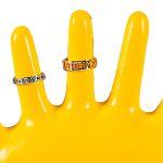 Two silver rings on yellow display stand