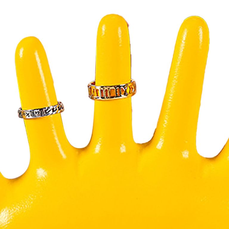 Two silver rings on yellow display stand