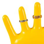 Silver rings on yellow hand display stand