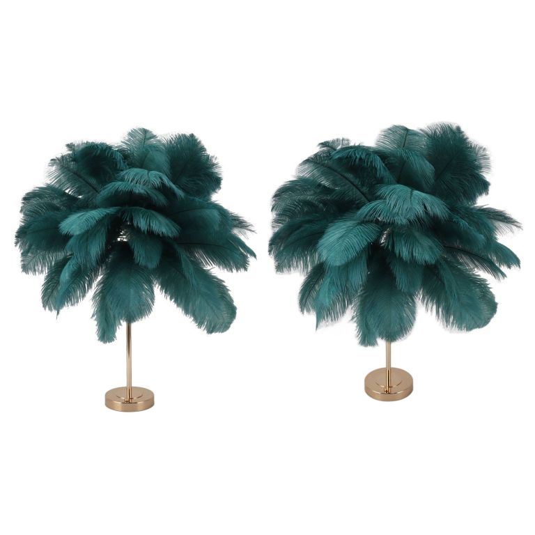 Two teal feather floor lamps with gold bases
