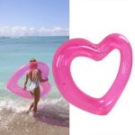 heart pool float pvc material skin friendly lightweight pink romantic style floating tubes for summer Woman carrying pink heart float at beach