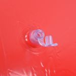 Close-up of inflatable valve on red surface