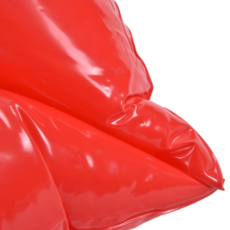 Close-up of glossy red plastic material folds