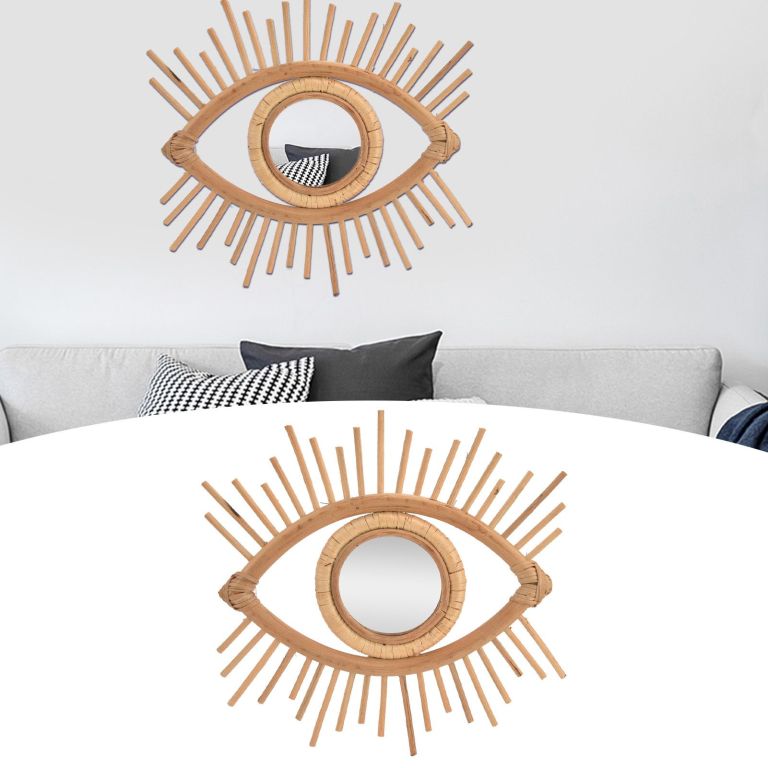 Eye-shaped rattan wall mirror above grey sofa