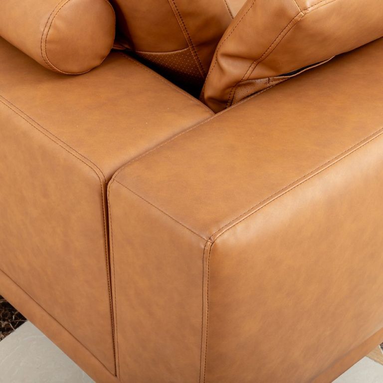 modern deep seated sofa, two seater, faux leather, brown brown pu leather Close-up of tan leather sofa corner