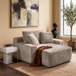 Modern beige armchair with ottoman in stylish lounge