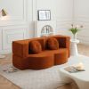 Burnt orange curved sofa in modern living room