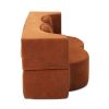 Rust velvet sculptural armchair with curved backrest