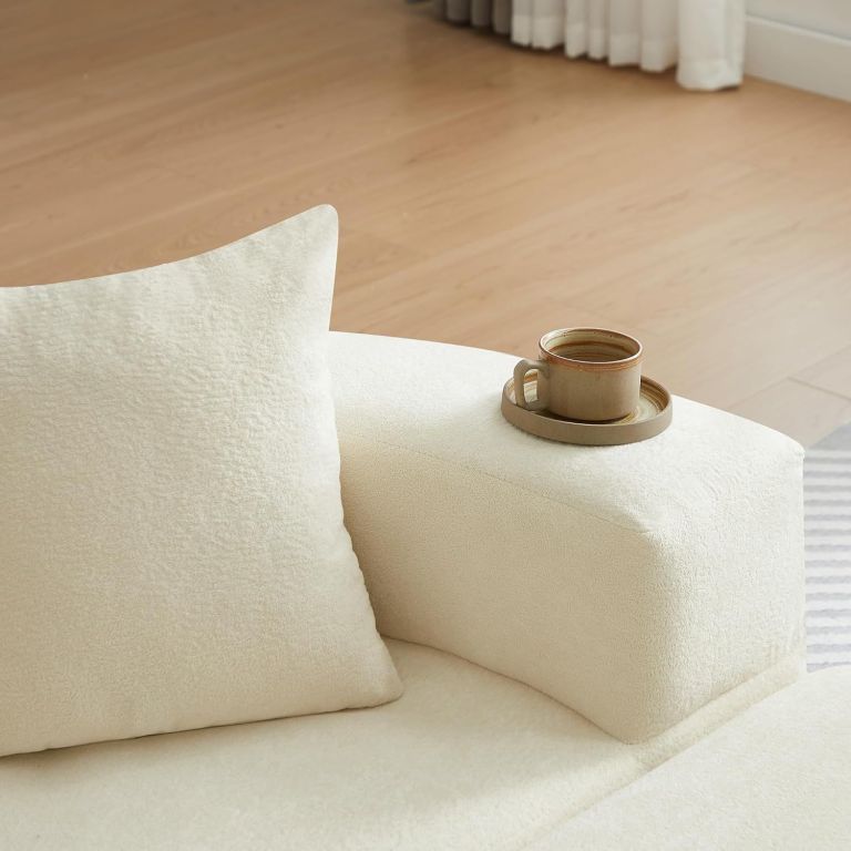 multifunctional round convertible sofa bed(compressed packaging) orange Ceramic coffee cup on cream sofa arm