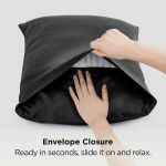 Hands placing pillow into black envelope pillowcase
