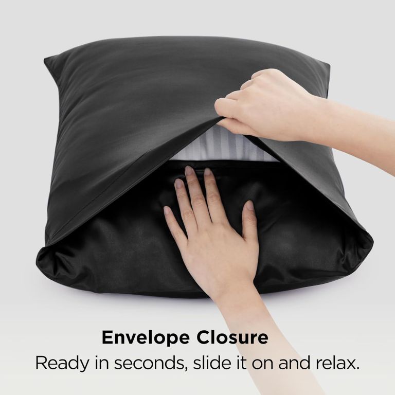 Hands placing pillow into black envelope pillowcase