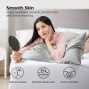 Woman admiring smooth skin in bed mirror