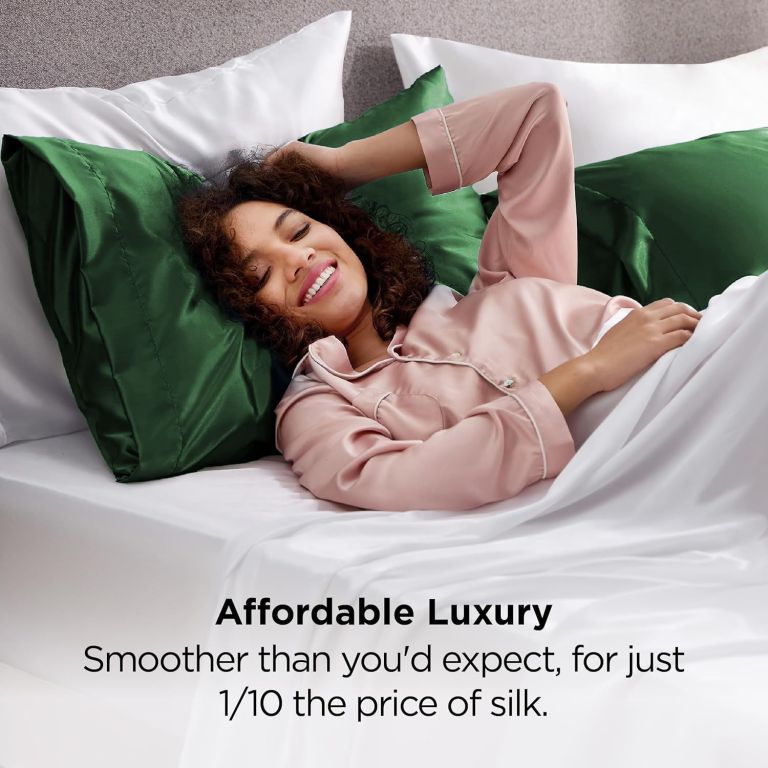 Woman relaxing on bed with green satin pillows