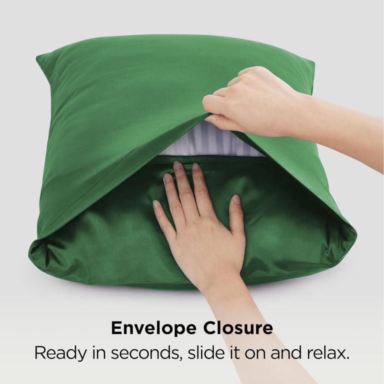Hands fitting green pillowcase with envelope closure