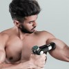 fitsmart lcd display mini vibration therapy massage device black Man using massage gun on bicep