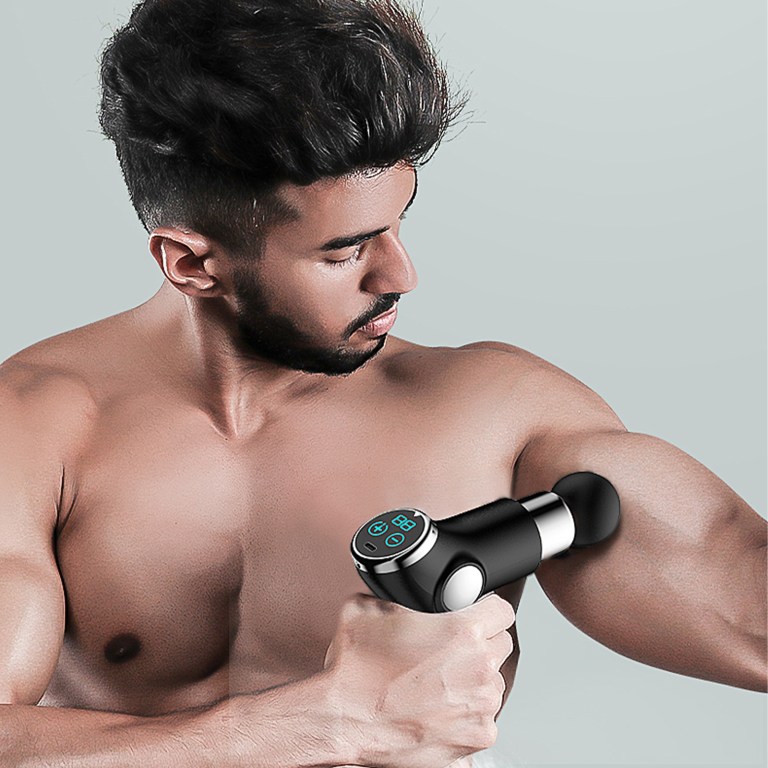 Man using massage gun on bicep