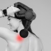 fitsmart pro vibration therapy massage device black and white Woman using massage gun on sore shoulder