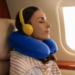Woman relaxing with headphones on aeroplane