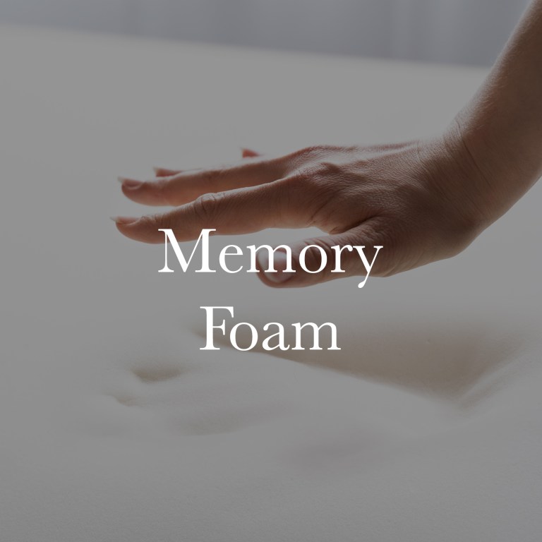 Hand pressing into white memory foam mattress