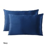 Two navy blue satin pillowcases on white background