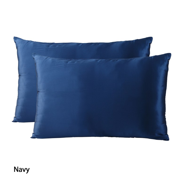 Two navy blue satin pillowcases on white background