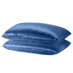 Two blue satin pillows stacked on white background