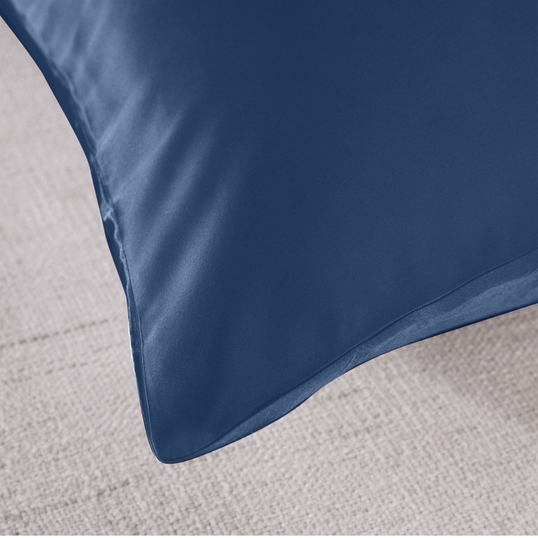 Close-up of blue cushion corner on carpet