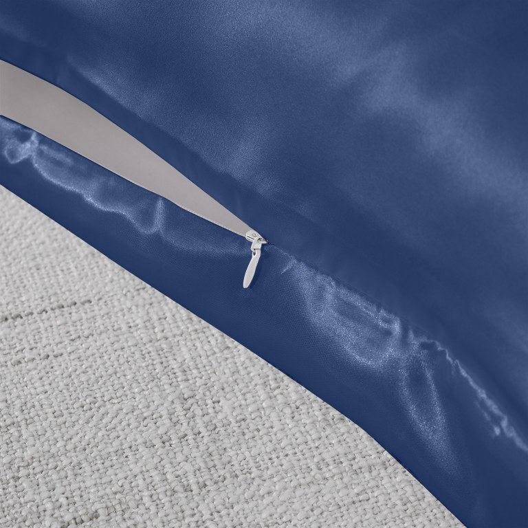 Close-up of blue cushion cover with white zipper