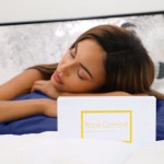 Woman resting on silk pillowcase beside product box