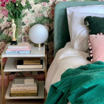 Floral bedroom with bedside table and globe lamp