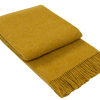 Folded mustard throw blanket with fringed edges