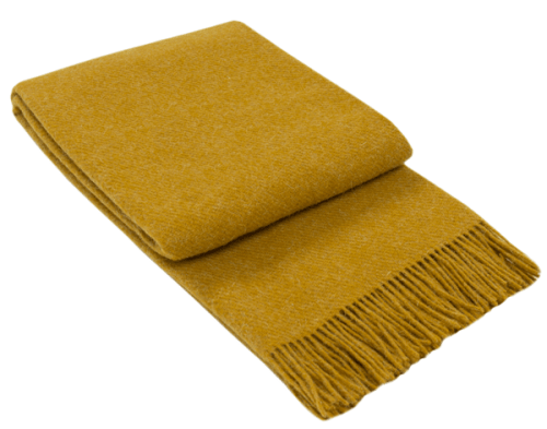 Folded mustard throw blanket with fringed edges