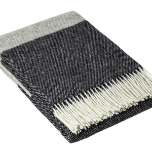 Folded grey and black fringed throw blanket