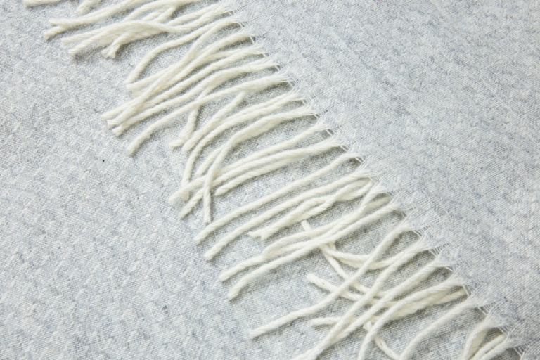 Close-up of fringed wool throw blanket