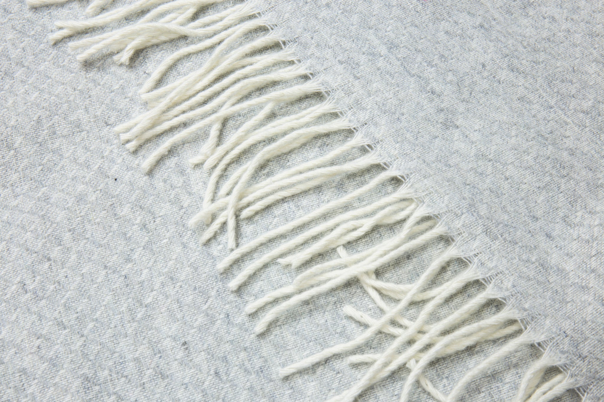 Close-up of fringed wool throw blanket